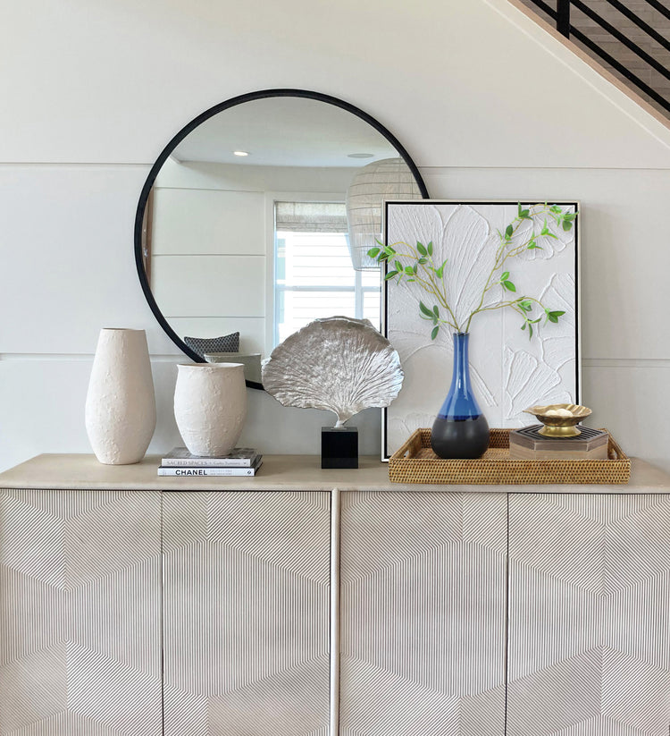 Eco Handcraft rattan tray styled on entryway console with vase, decor books, and silver leaf sculpture in modern coastal setting