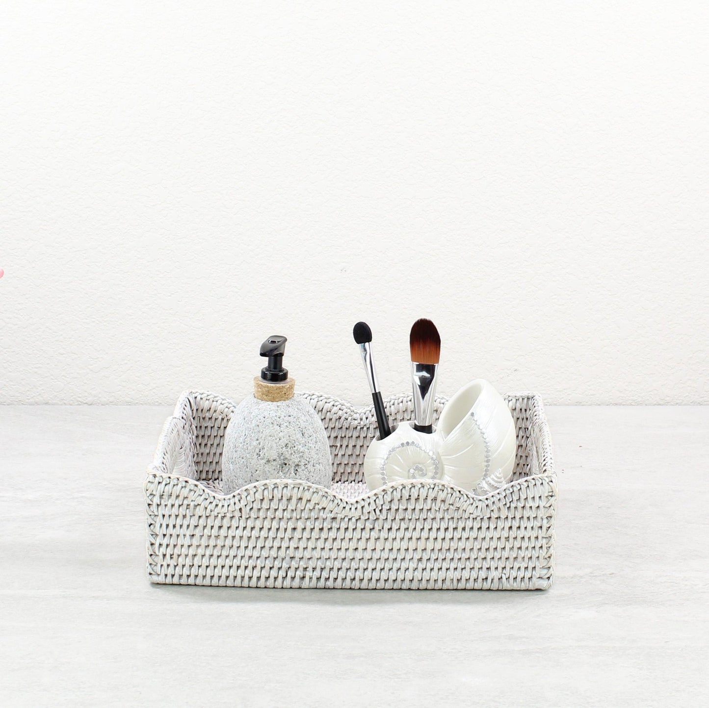 Eco Handcraft whitewash scalloped rattan tray styled with soap dispenser and makeup brushes