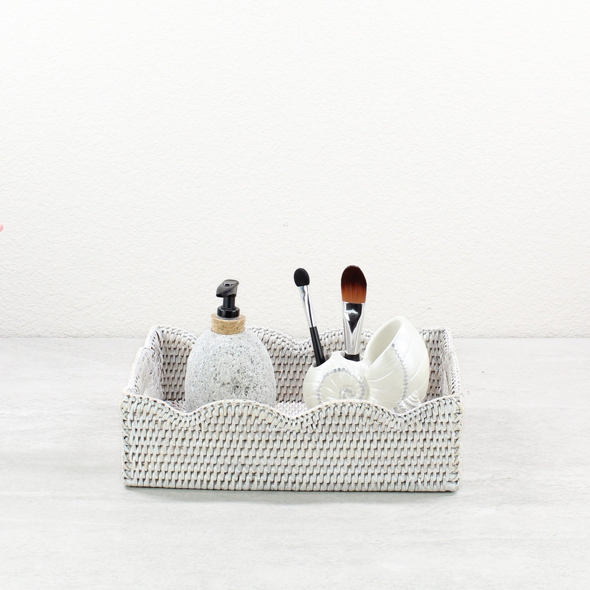 Eco Handcraft whitewash scalloped rattan tray styled with soap dispenser and makeup brushes