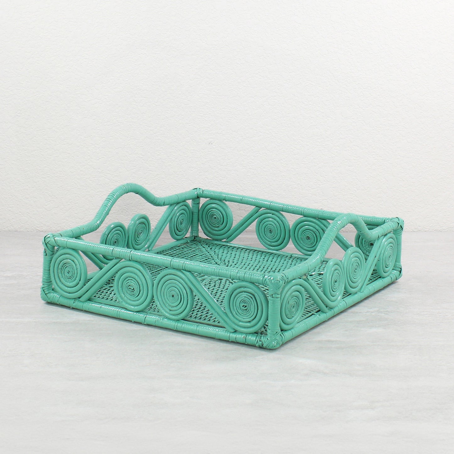 Turquoise scroll-handle square rattan tray on light background, perfect for serving or display