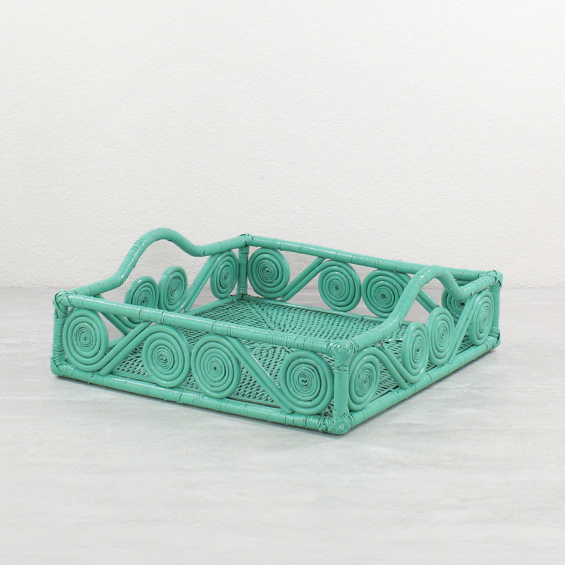 Turquoise scroll-handle square rattan tray on light background, perfect for serving or display