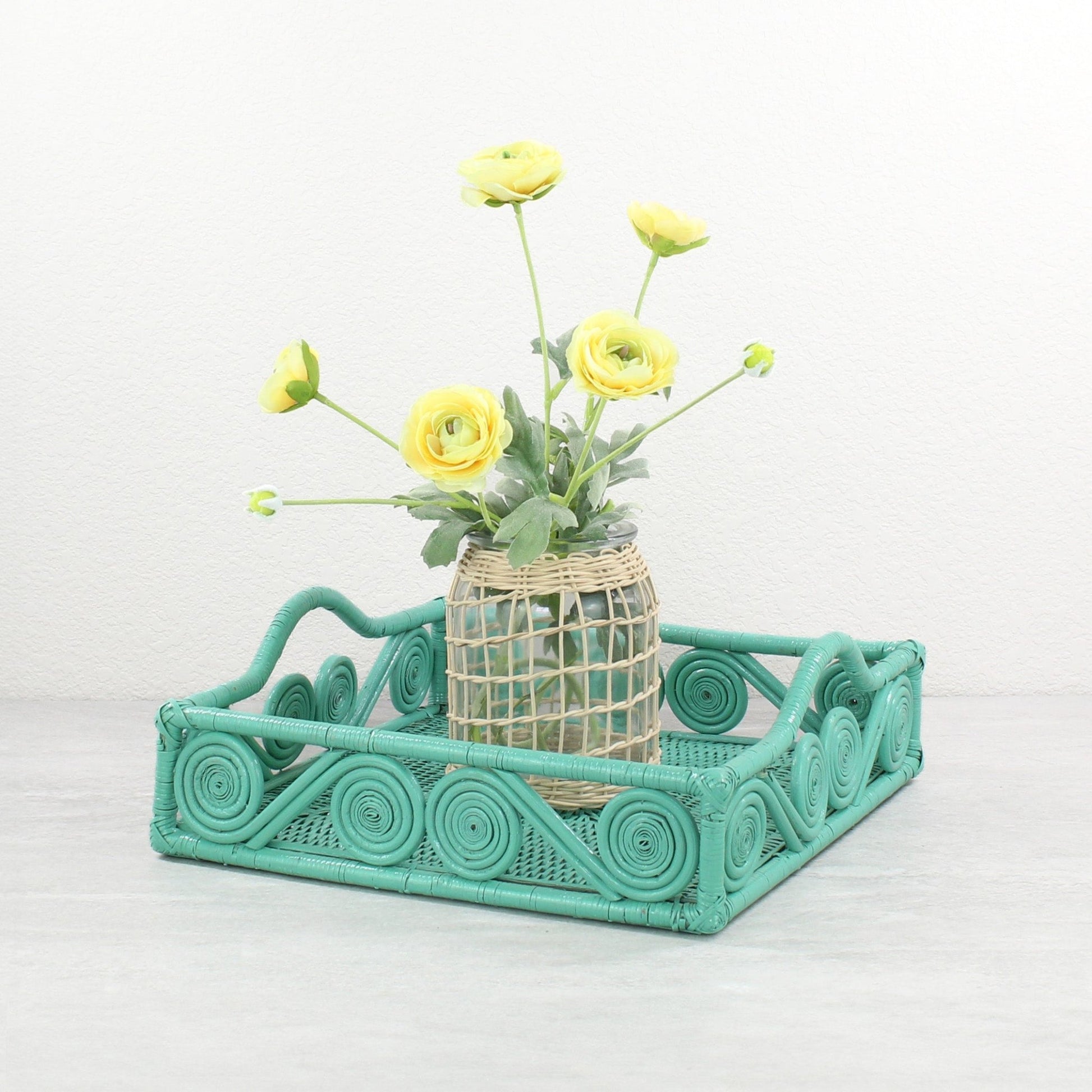 Eco Handcraft turquoise scroll rattan tray with vase of yellow flowers for spring or dining table styling