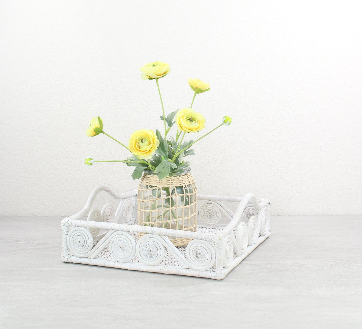 Eco Handcraft whitewash rattan swirly tray styled with glass flower vase for elegant kitchen, coffee table, or entryway décor