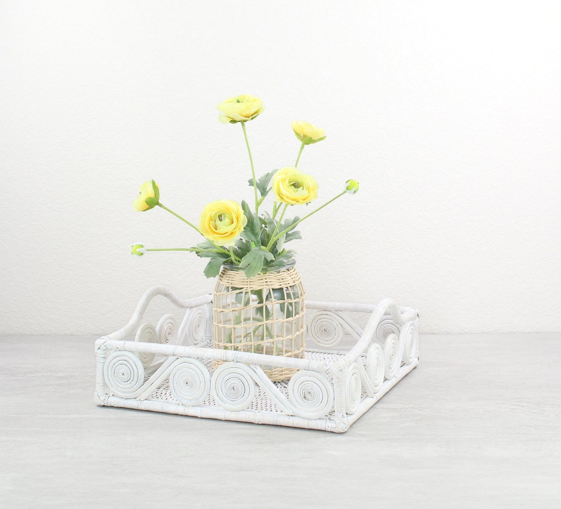 Eco Handcraft whitewash rattan swirly tray styled with glass flower vase for elegant kitchen, coffee table, or entryway décor