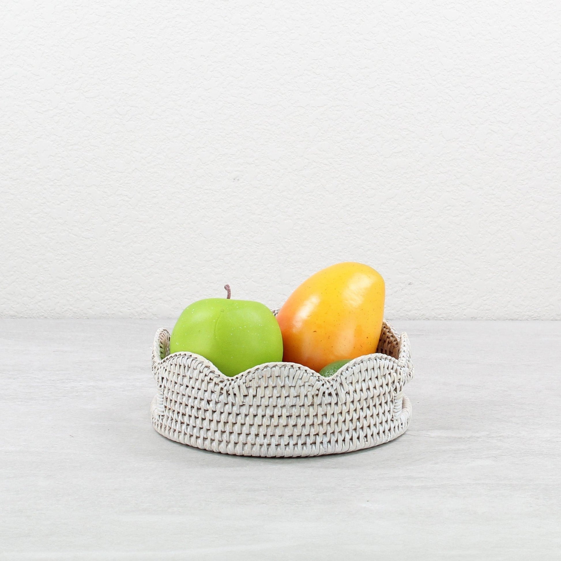 ECO HANDCRAFT whitewashed scalloped rattan tray styled with fruit, ideal for rustic kitchen, serving, or countertop use