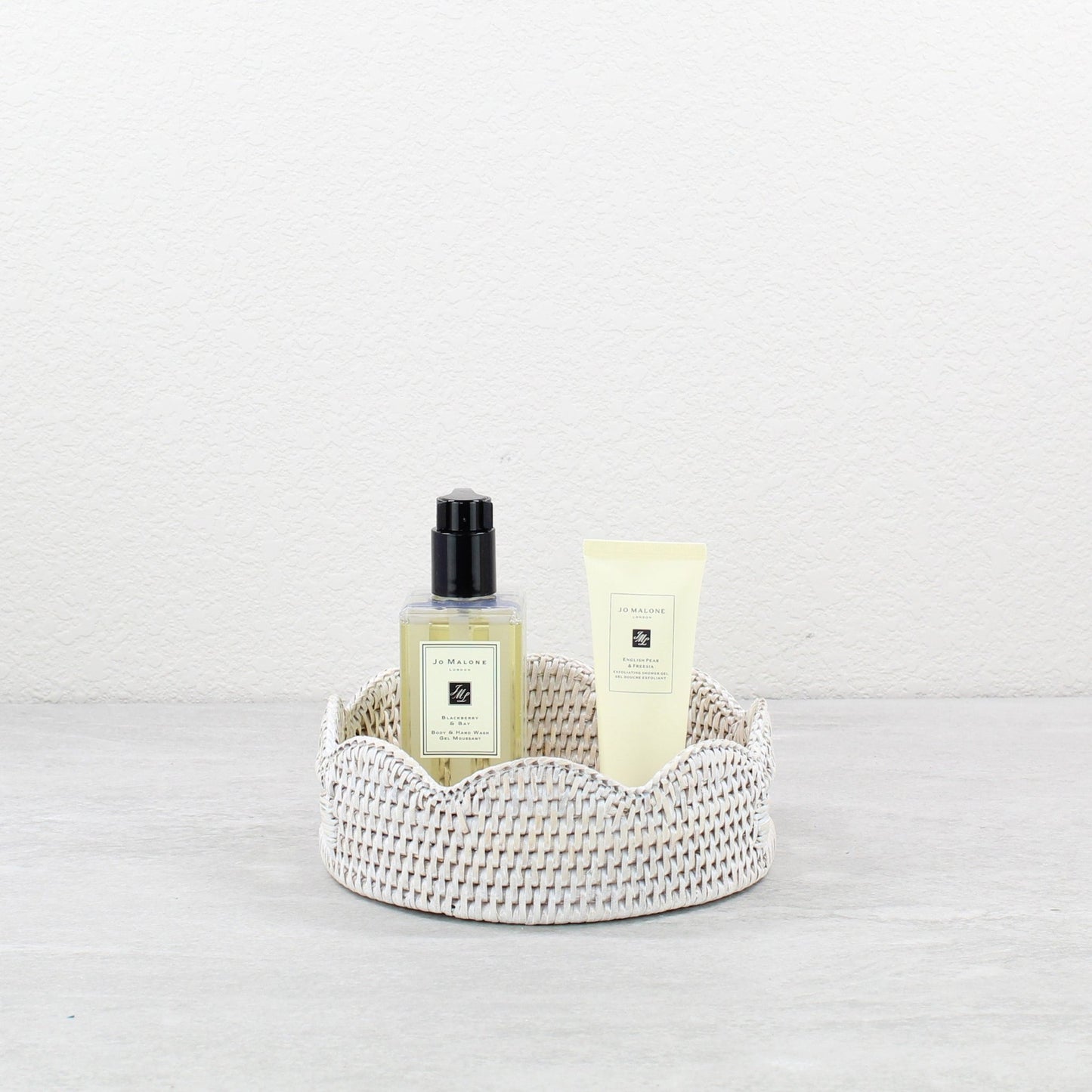 Eco Handcraft whitewash round scalloped rattan tray with Jo Malone beauty products