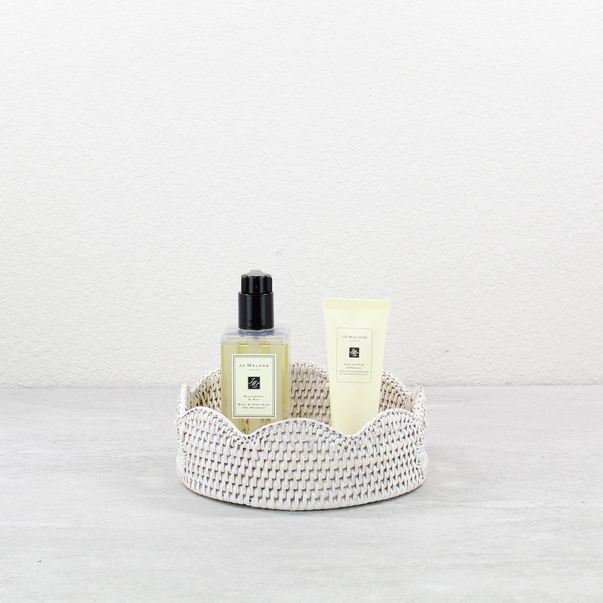 Eco Handcraft whitewash round scalloped rattan tray with Jo Malone beauty products