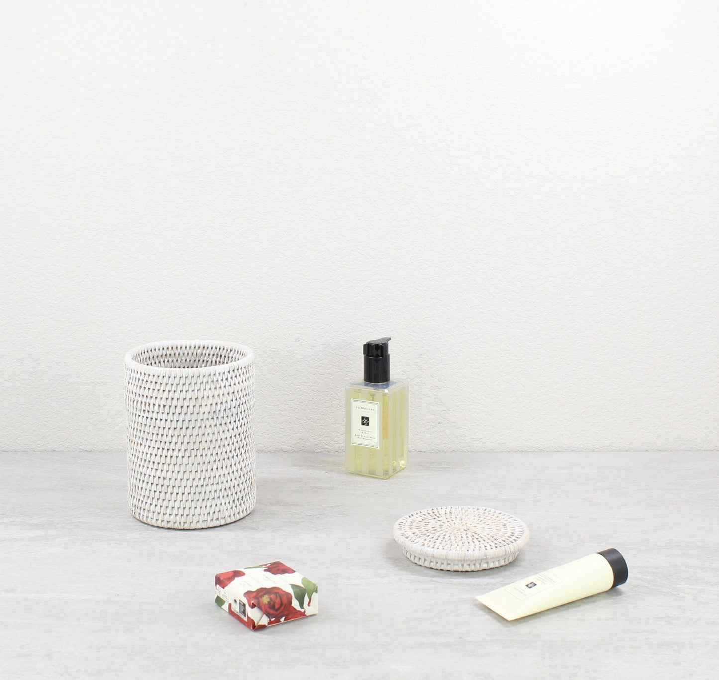 Eco Handcraft whitewash rattan canister styled with Jo Malone and soap for luxury bathroom organization