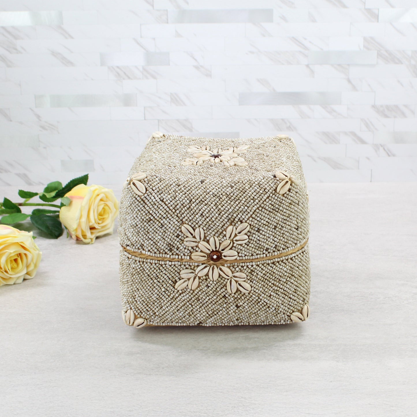 Medium beige beaded storage box decorated with natural cowrie shells in coastal boho décor style.