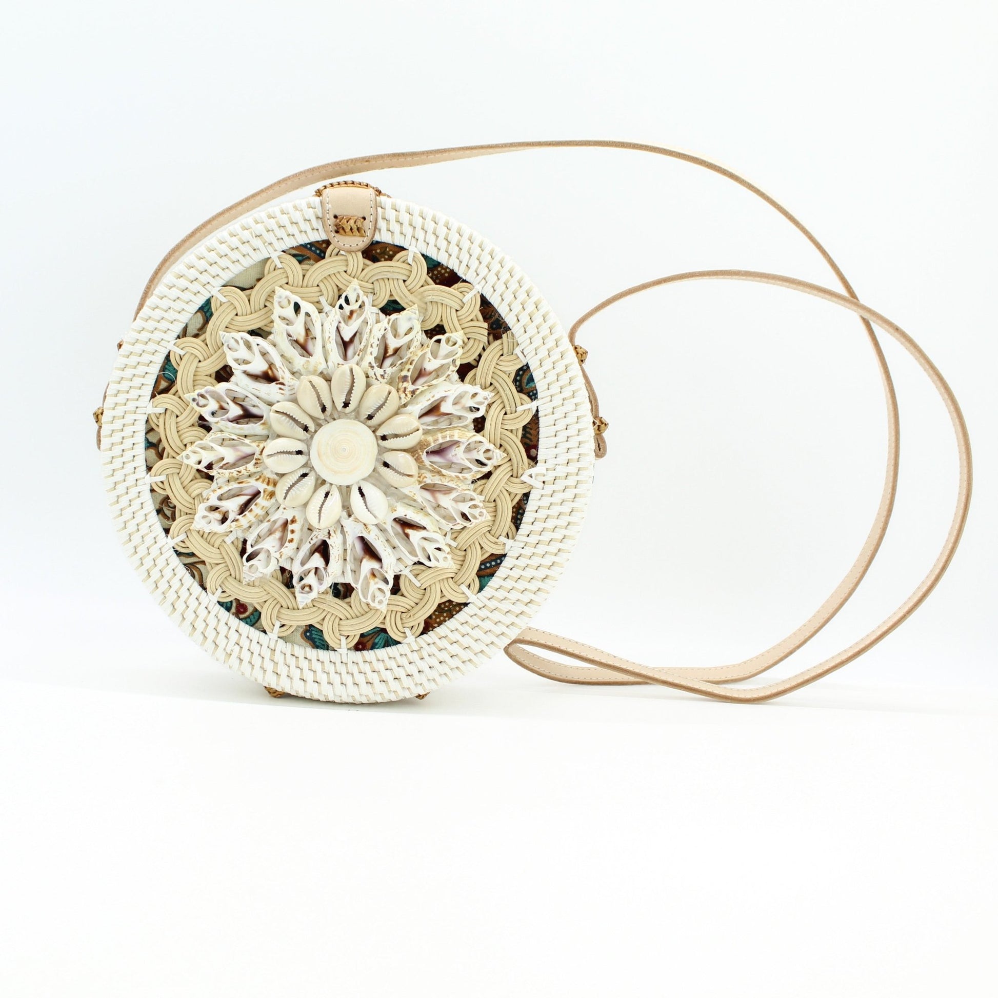Model wearing seashell rattan crossbody bag with flower design, styled for a chic coastal look with neutral summer outfit