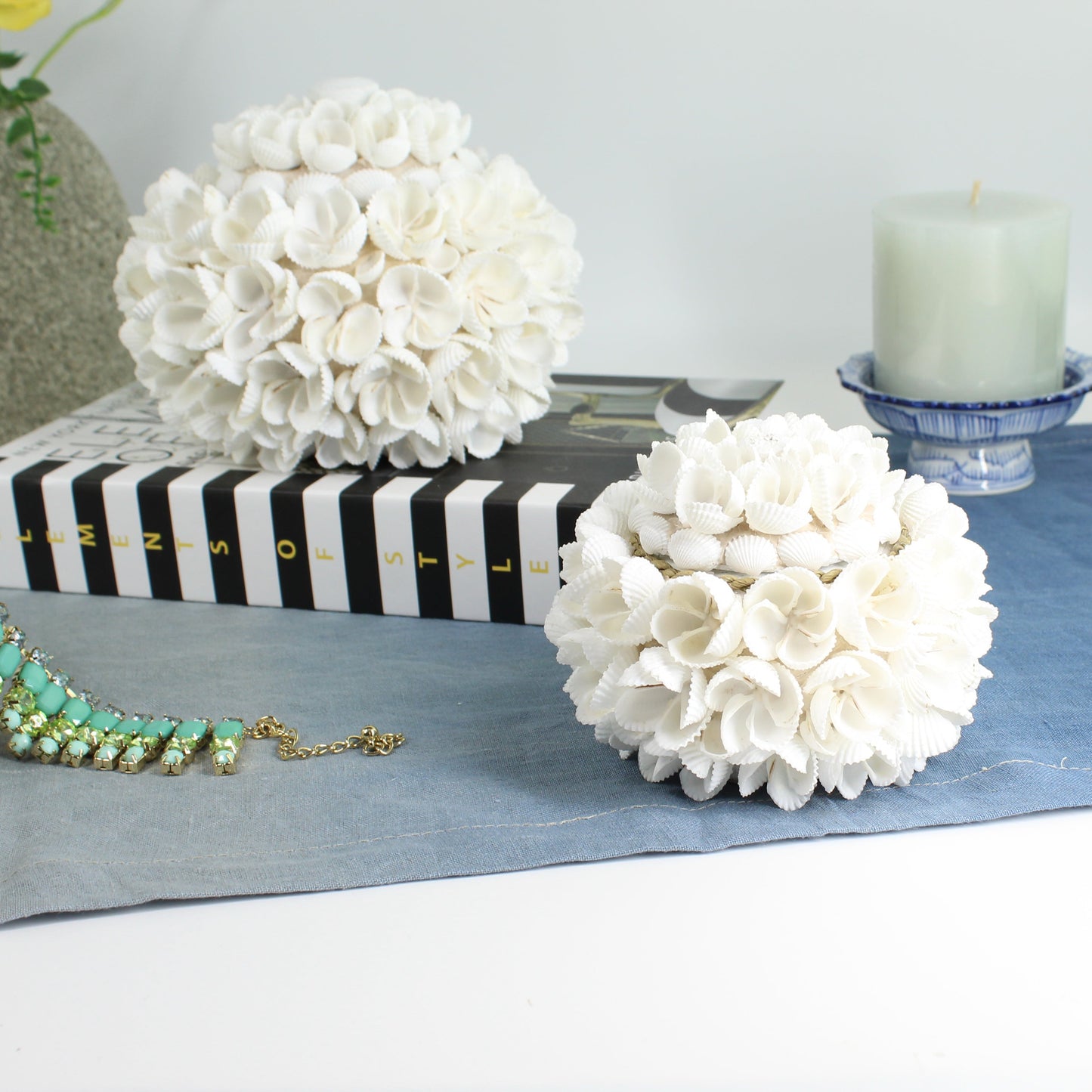 Small handmade seashell blossom storage box with floral shell design, styled with jewelry and candle, perfect as a coastal keepsake or trinket holder.