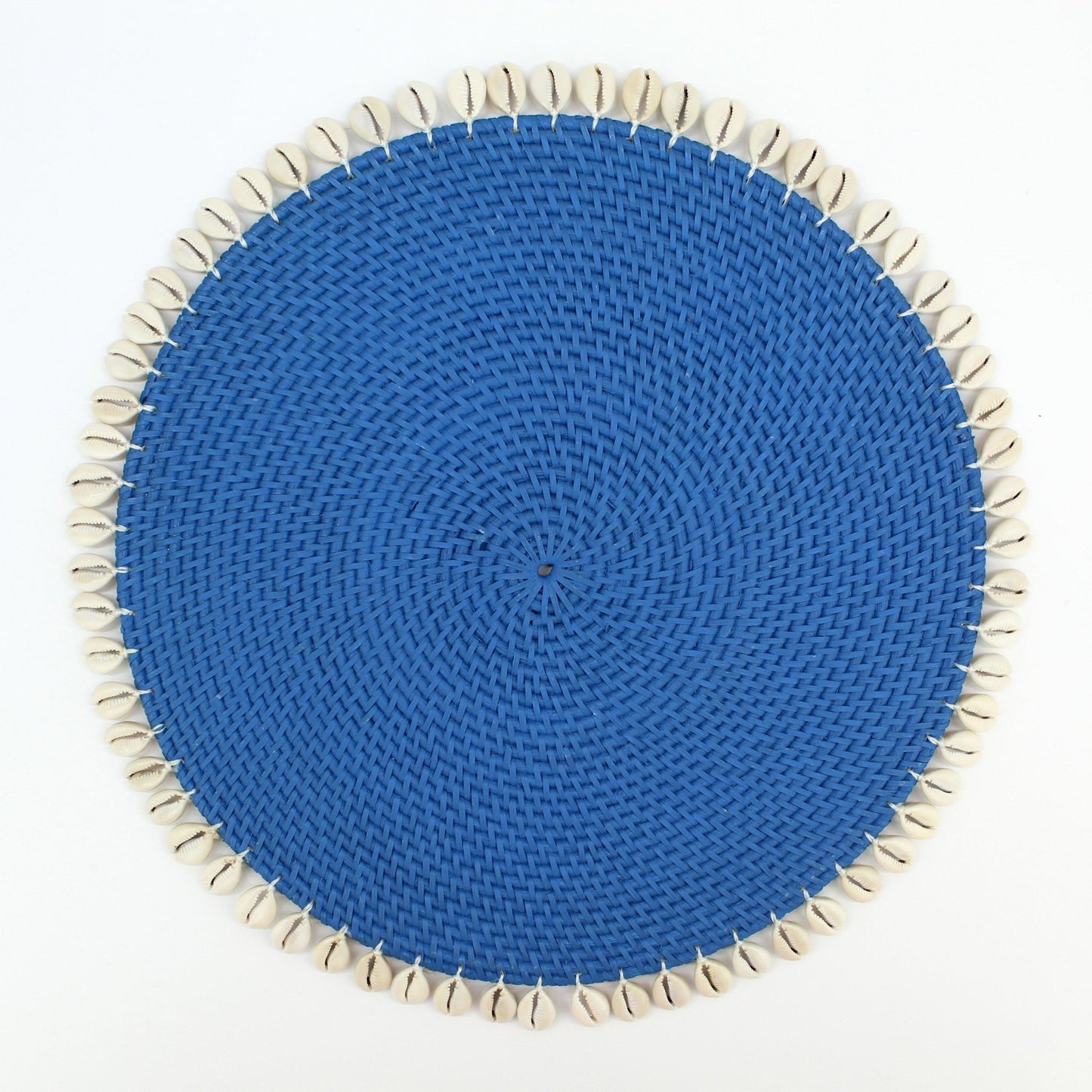 Round blue rattan placemat with natural shell trim, handmade for coastal-style dining and eco-friendly homes