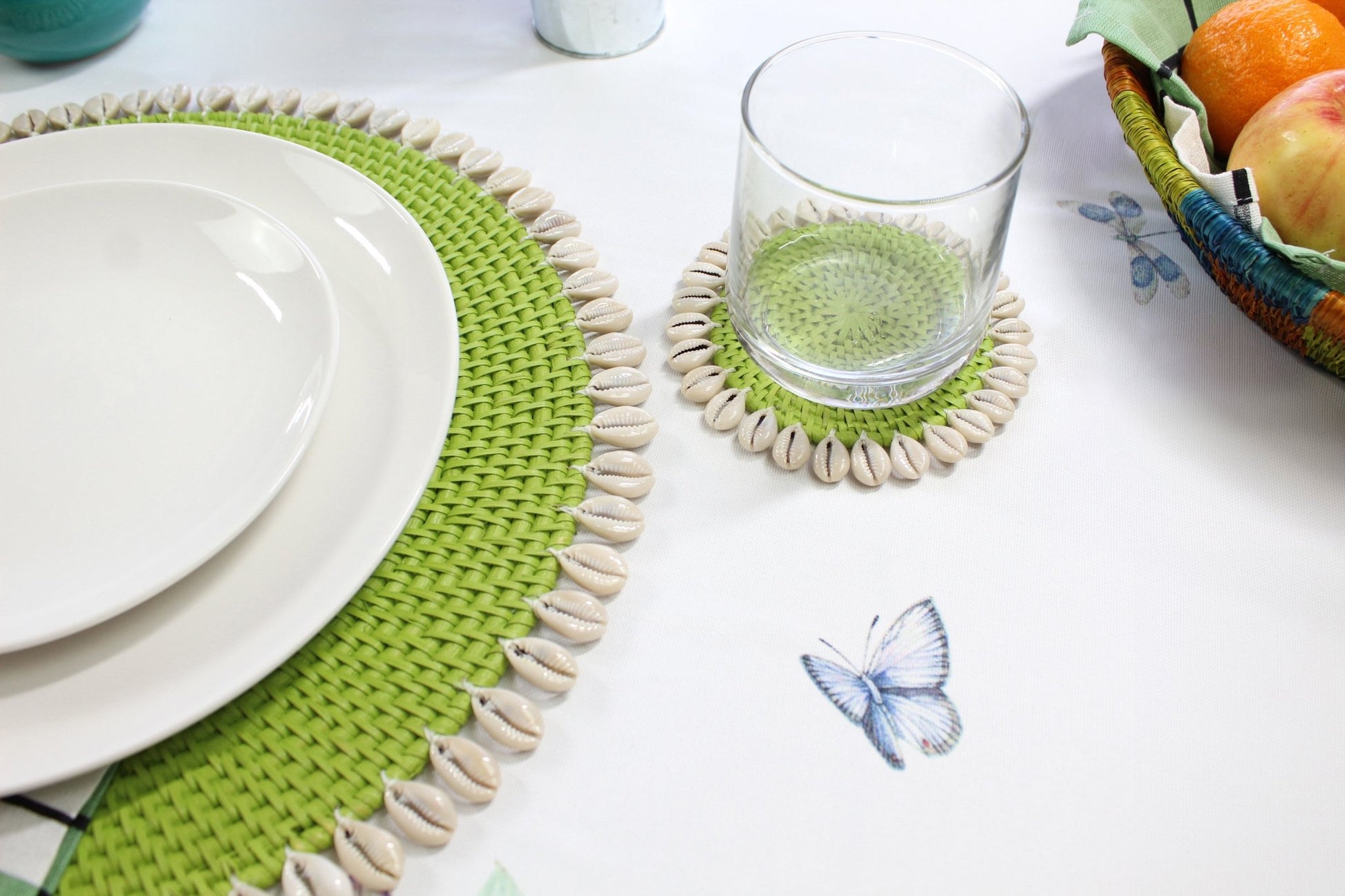 Lime Green eco-friendly rattan coasters styled in coastal home with candles, flowers, and tropical table décor