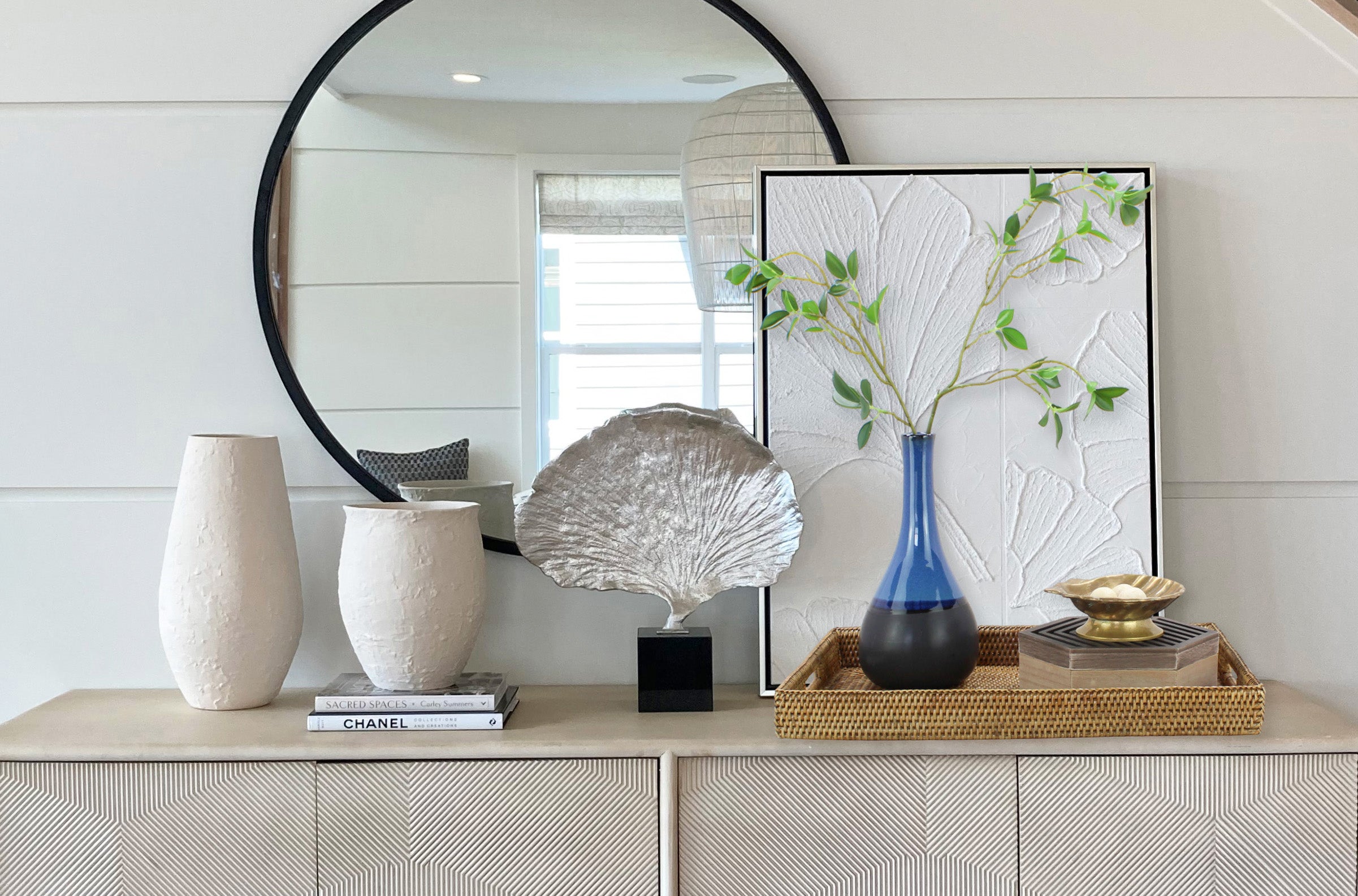 Eco Handcraft rattan tray styled on a modern entryway console with decorative vases, books, and wall art