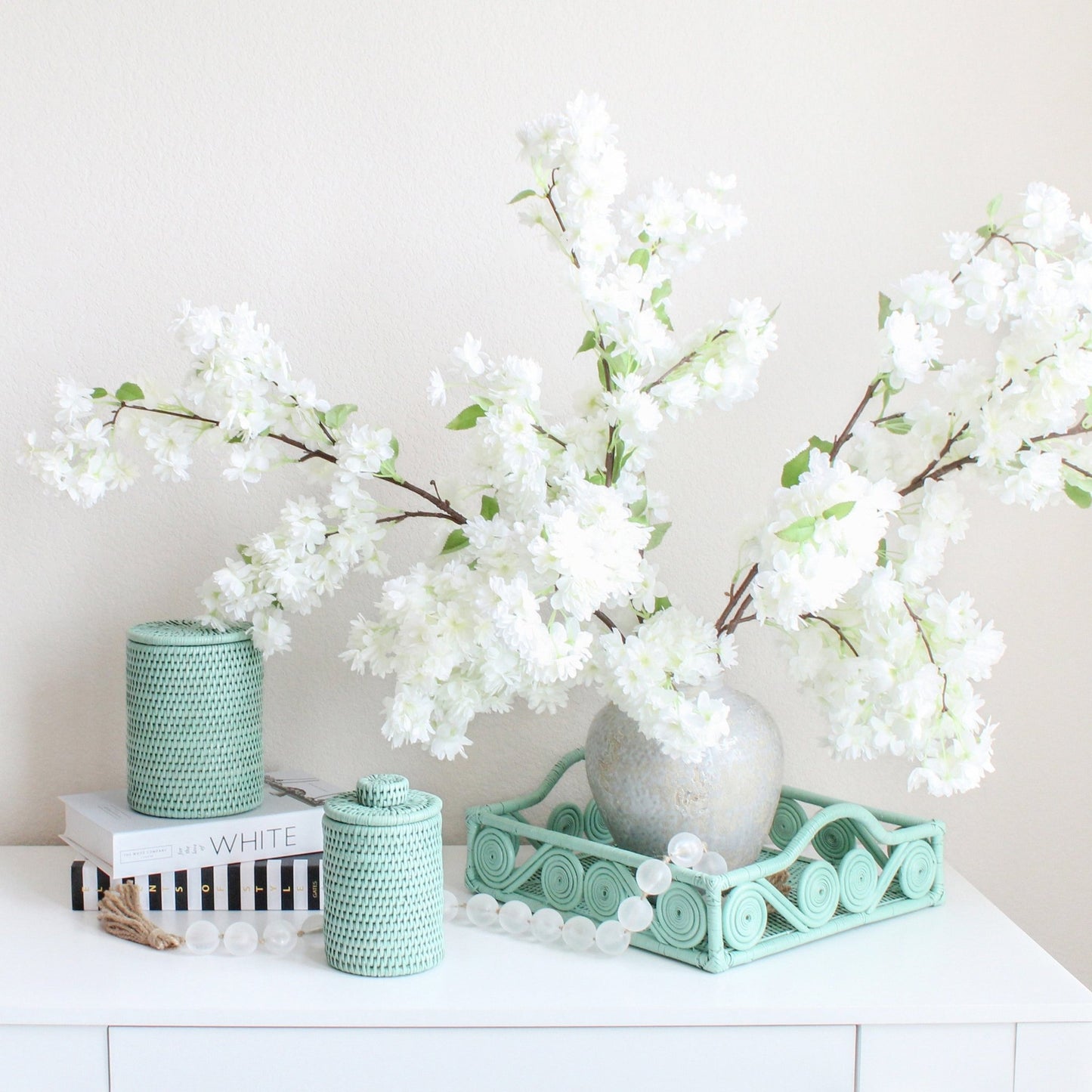 Eco Handcraft sage green rattan decor with white blossoms – handmade tray and canisters for elegant spring styling