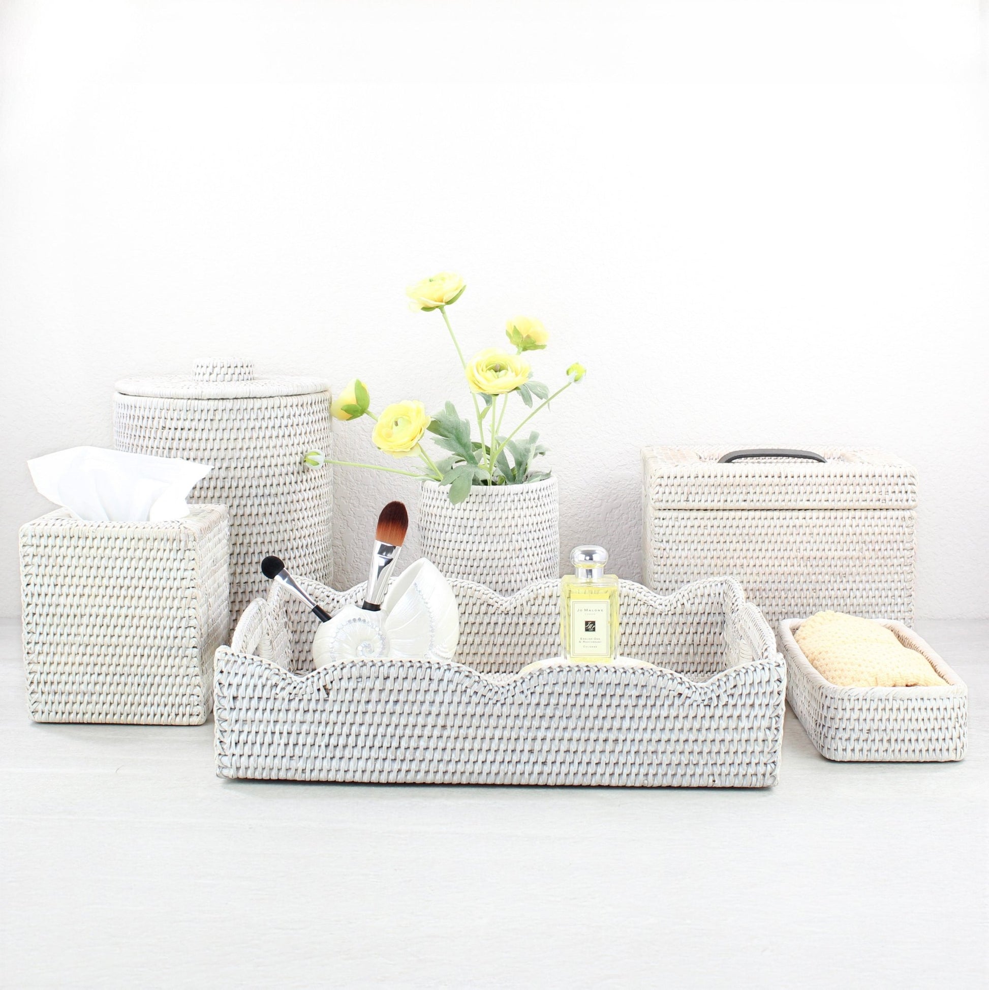 Eco Handcraft whitewash rattan bathroom set with tissue box, canister, scalloped tray, and organizer, styled with yellow flowers