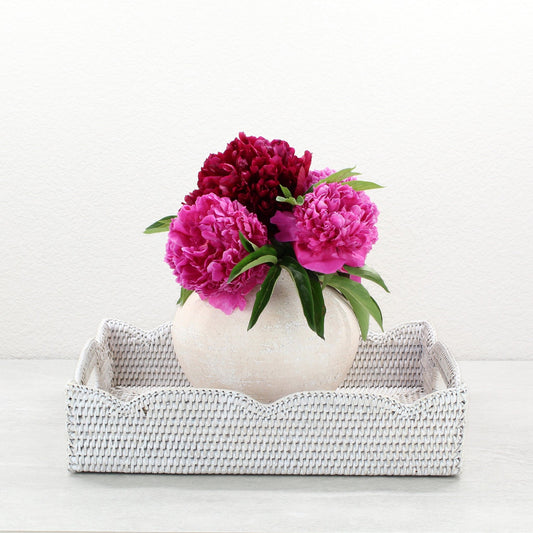 Eco Handcraft whitewash scalloped rattan tray styled with round vase and pink peonies