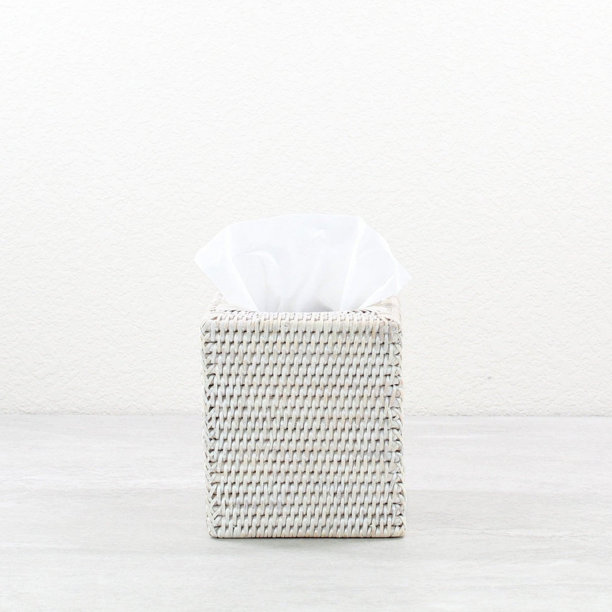 Eco Handcraft whitewash woven rattan square tissue box holder with white tissue on minimalist background