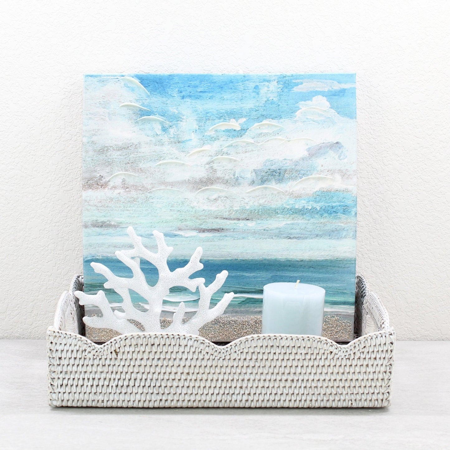 Eco Handcraft scalloped rattan tray styled with blue candle and coral art, ideal for coastal decor
