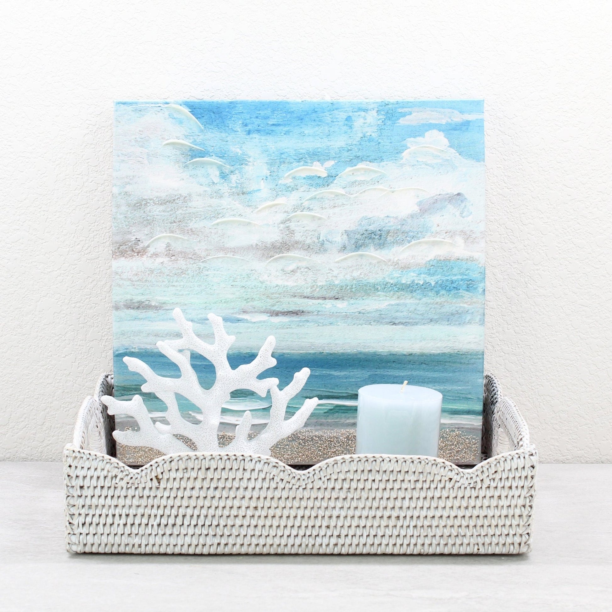 Eco Handcraft scalloped rattan tray styled with blue candle and coral art, ideal for coastal decor