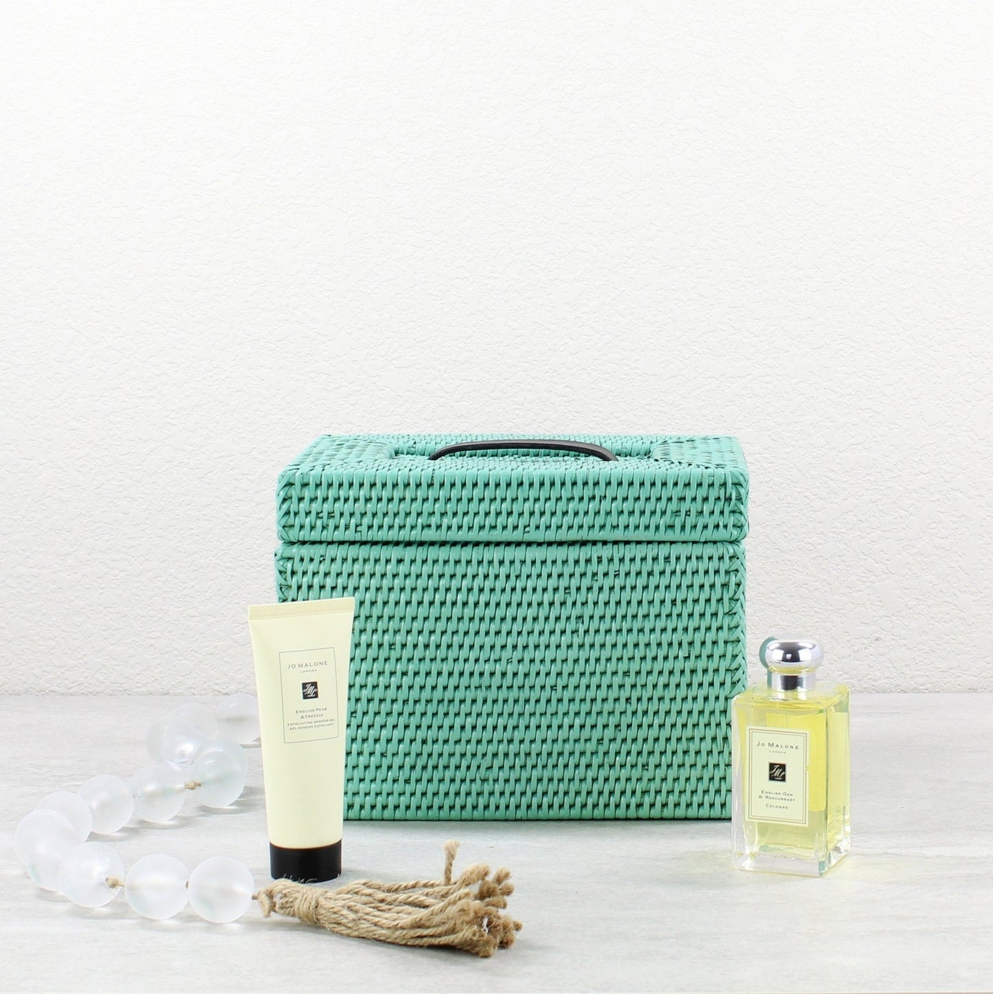 Eco Handcraft turquoise rattan storage box styled with Jo Malone products for luxury U.S. bathroom inspiration
