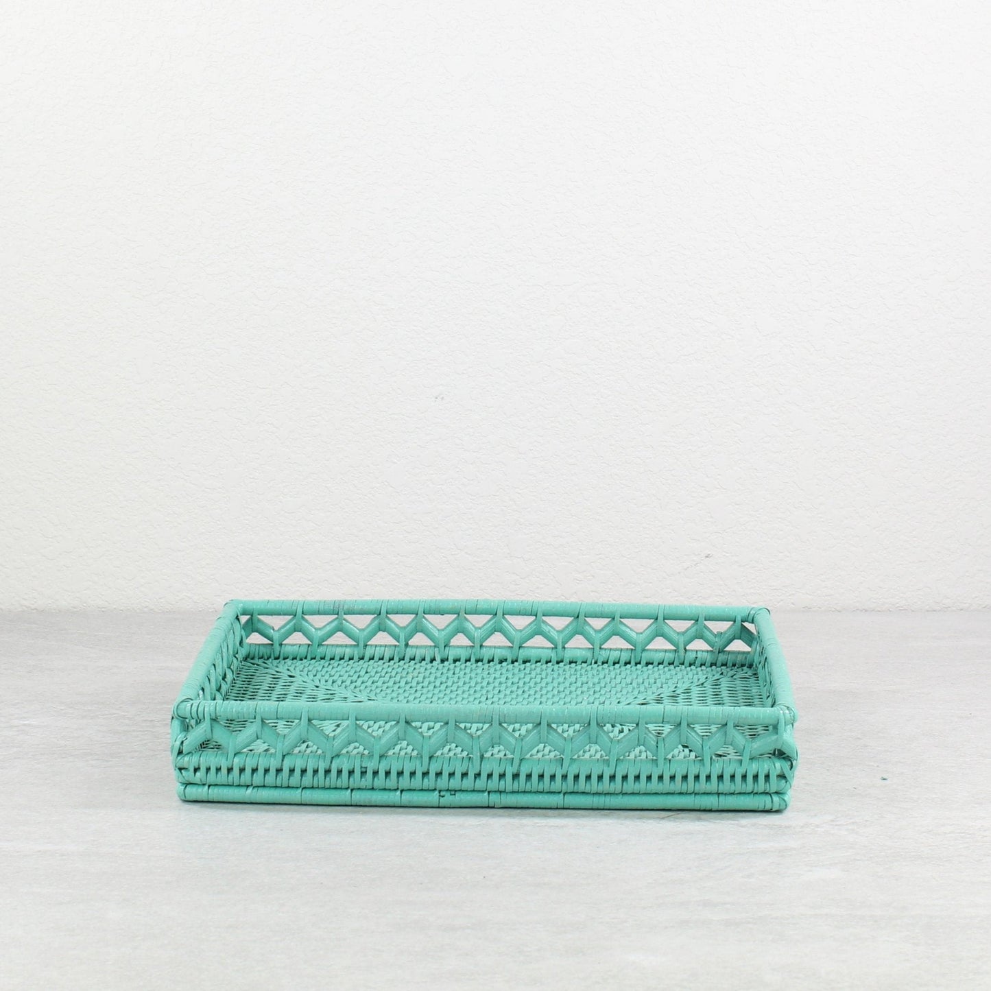 Turquoise rattan rectangular tray with open lattice side details, handcrafted with geometric patterns.