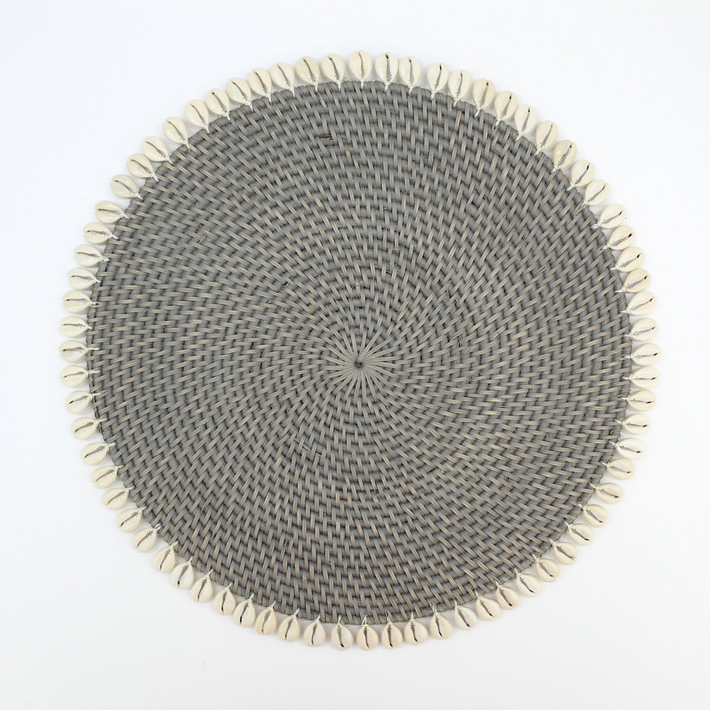 Handmade grey rattan placemat with natural seashell trim, shown on white background for clean, product-only display