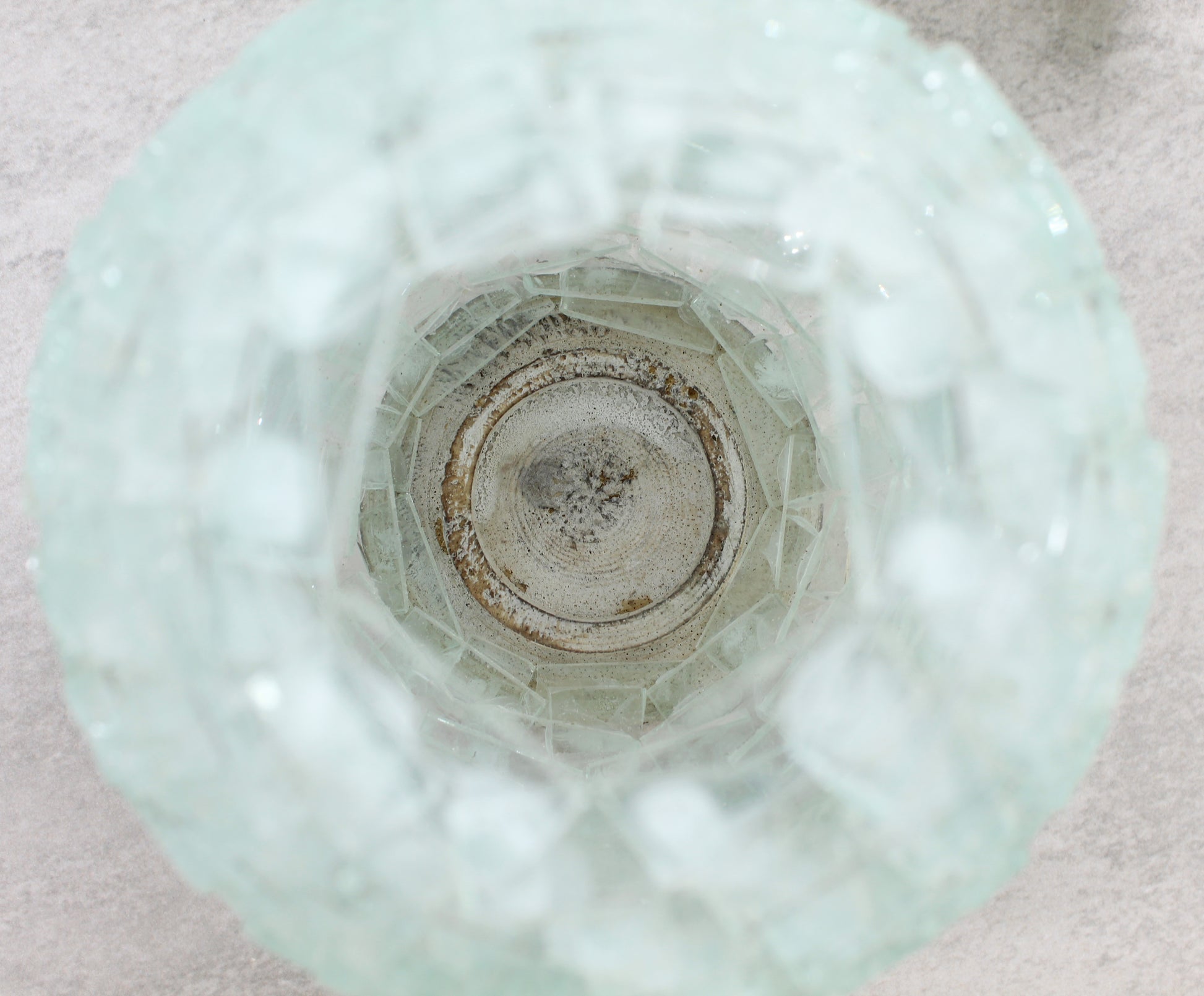 Close-up of the handmade pineapple glass tea light holder interior showing natural wood base and layered glass craftsmanship for light reflection.