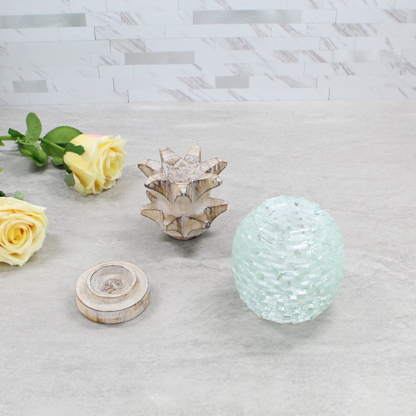 Handcrafted pineapple tea light holder shown in separated parts — wooden top, glass center, and wooden base — highlighting handmade construction and detail.