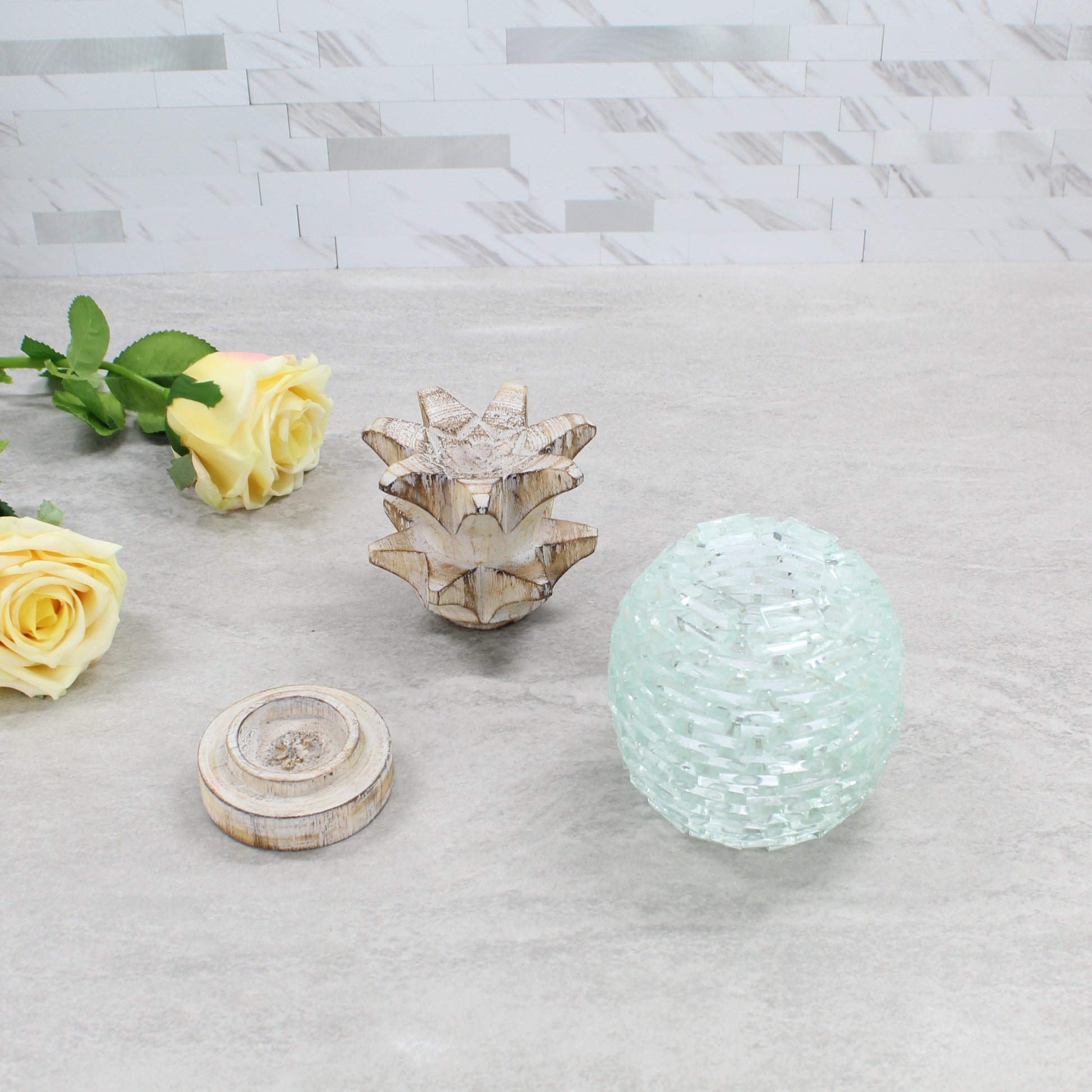 Handcrafted pineapple tea light holder shown in separated parts — wooden top, glass center, and wooden base — highlighting handmade construction and detail.