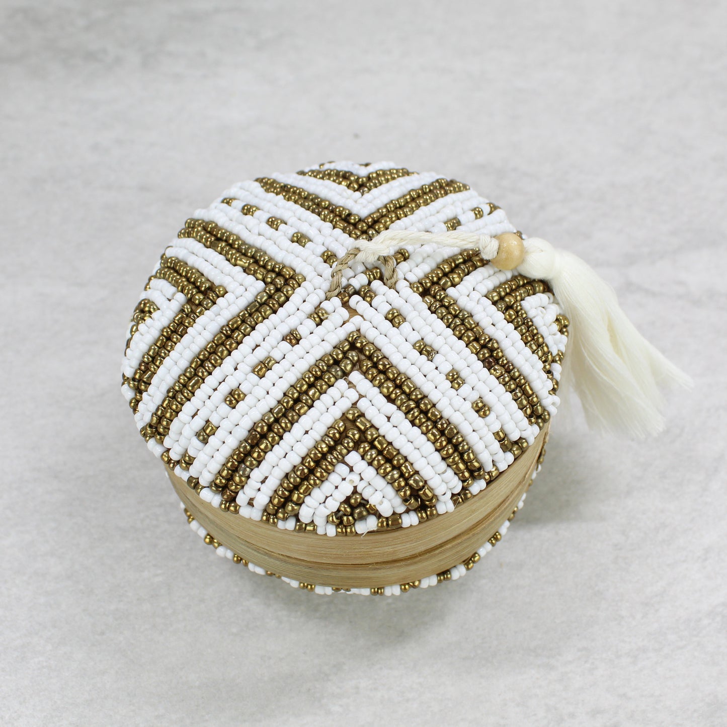 Eco Handcraft chevron-patterned white and gold beaded bamboo tassel box styled with yellow roses for elegant boho home décor.