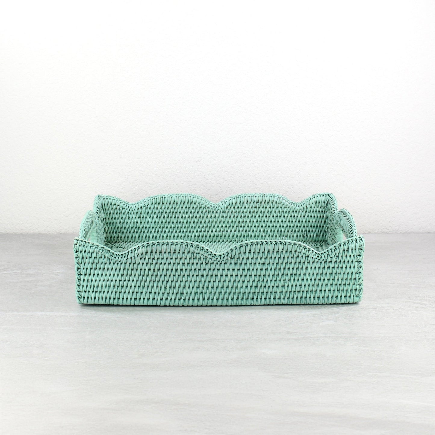Handwoven scalloped edge medium rectangle rattan tray in sage leaf green, ideal for serving, modern decorating, and organizing.