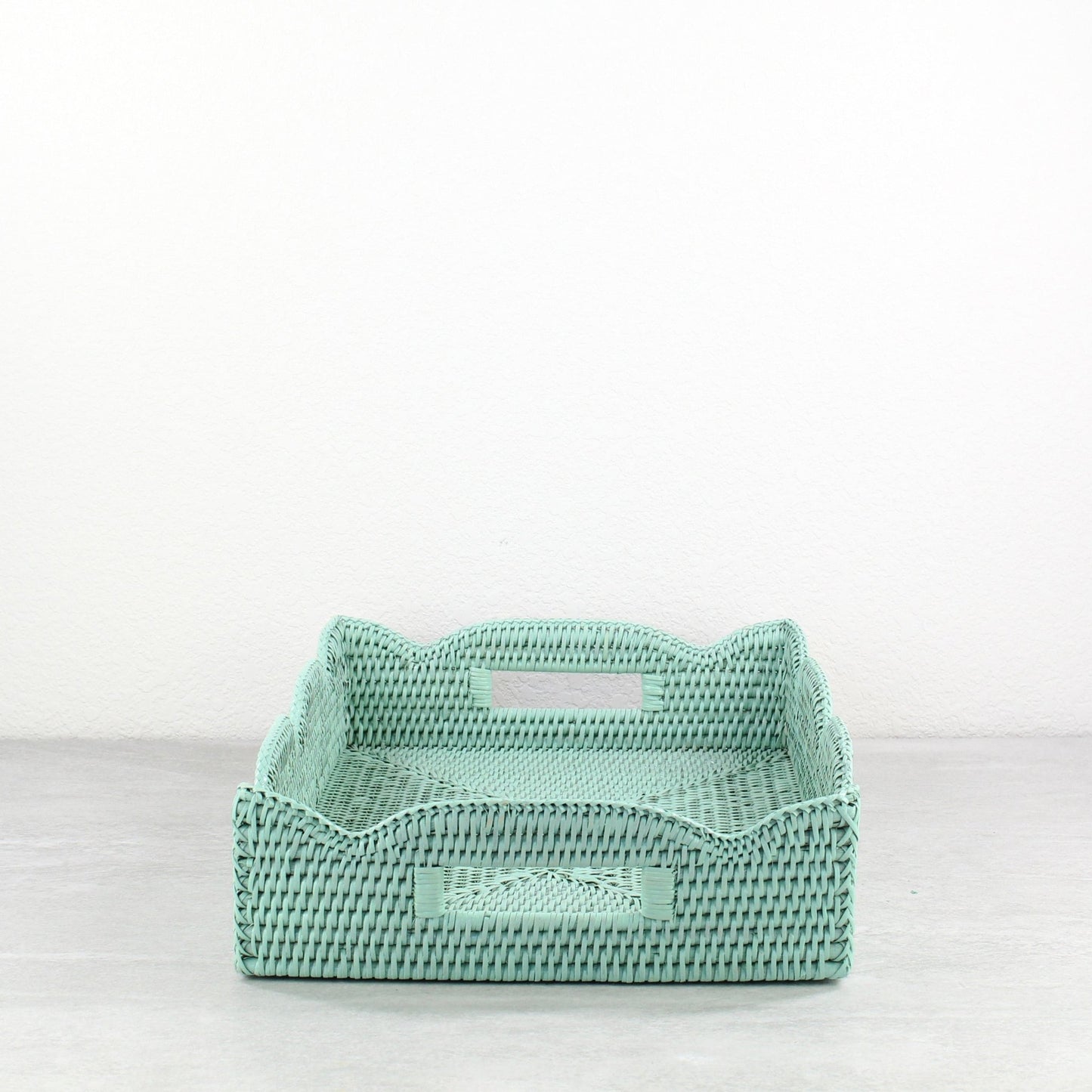 Sage Leaf Green scalloped rattan tray with wave edge design and handles, displayed in front view.