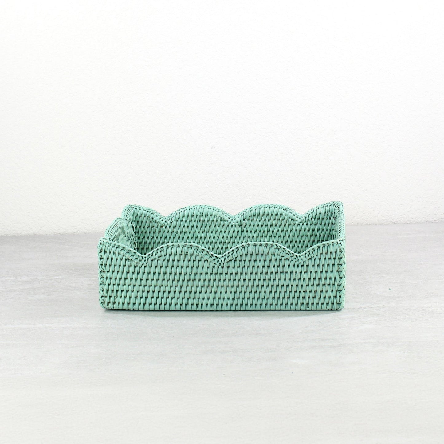 Sage Leaf Green scalloped rattan tray with woven texture and handles, shown in side view on a neutral background.