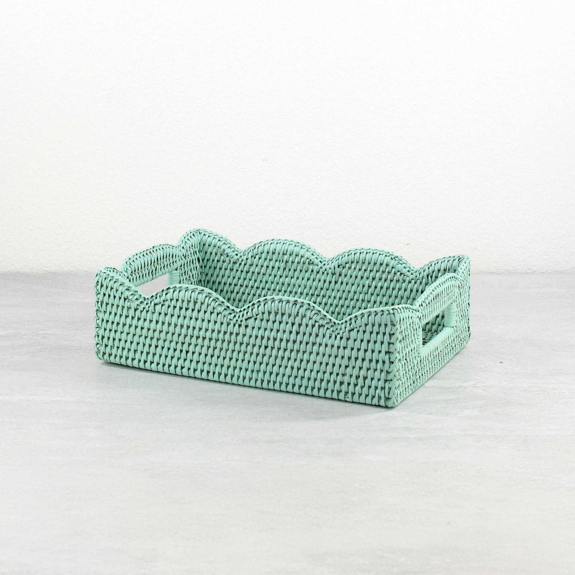 Handwoven small scalloped edge rectangle rattan tray in sage leaf green, ideal for serving, organizing, and decorating.