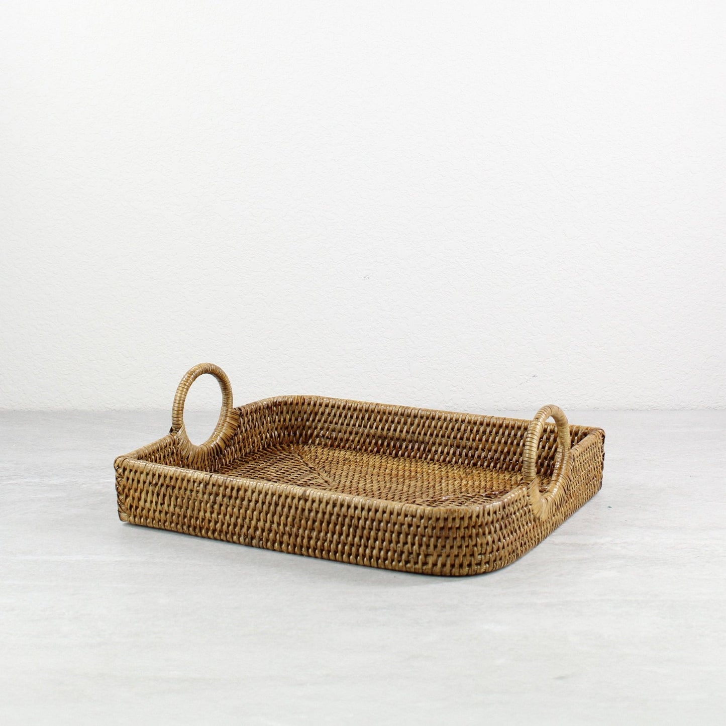 ECO HANDCRAFT brown rectangular rattan tray with circle handles, handmade for serving or stylish home organizing.