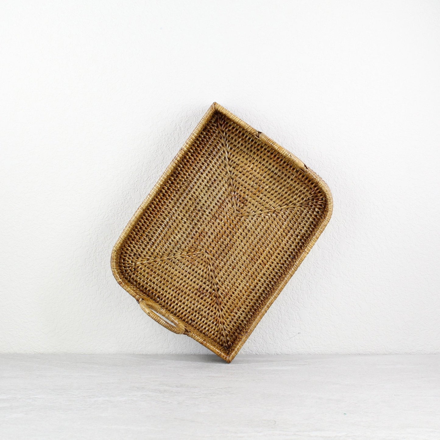 ECO HANDCRAFT rectangular brown rattan tray with handles, handmade for serving, organizing, or rustic decor use.
