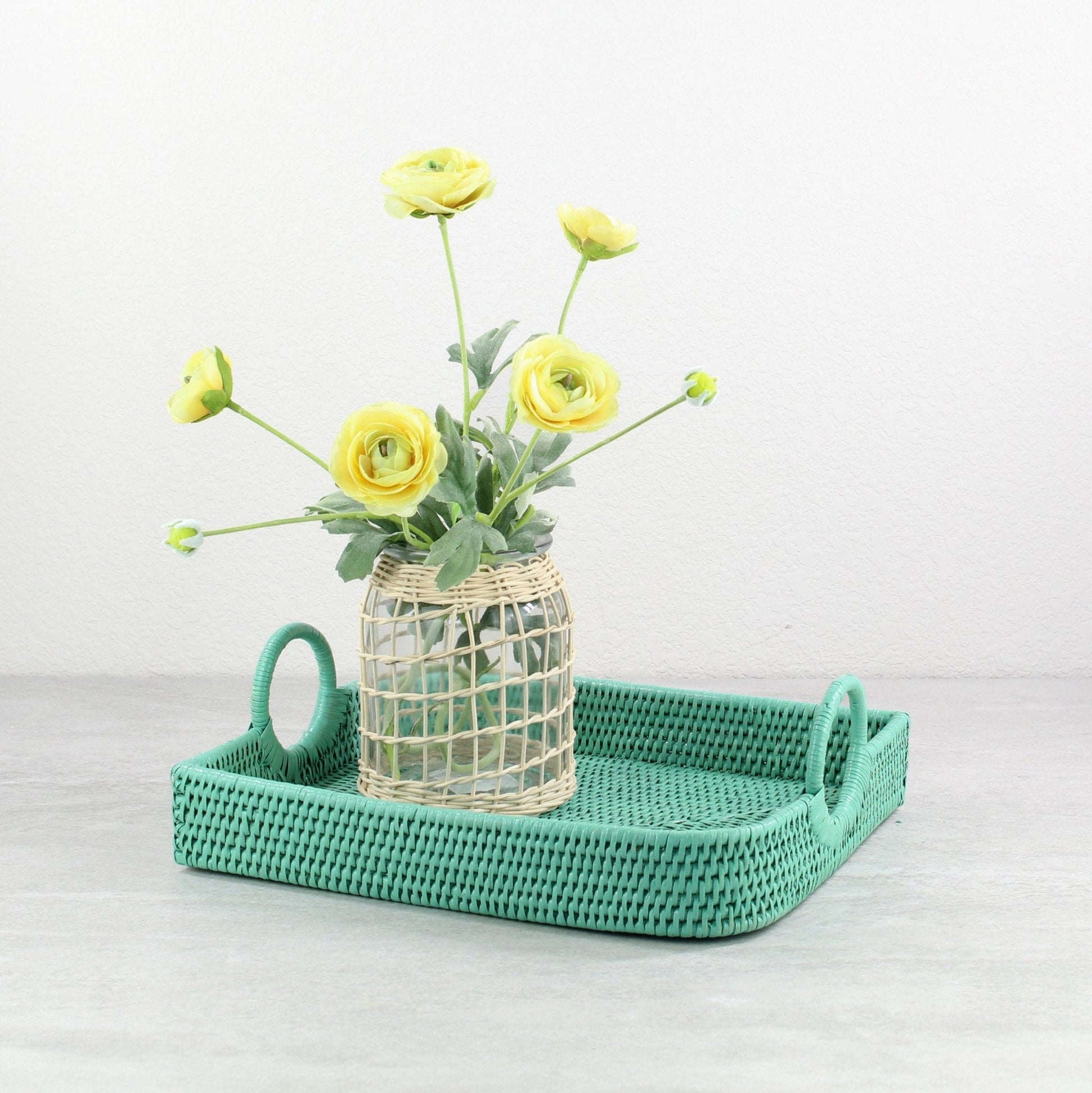 Eco Handcraft turquoise rattan tray with handles styled with glass flower vase, perfect for serving or spring table décor
