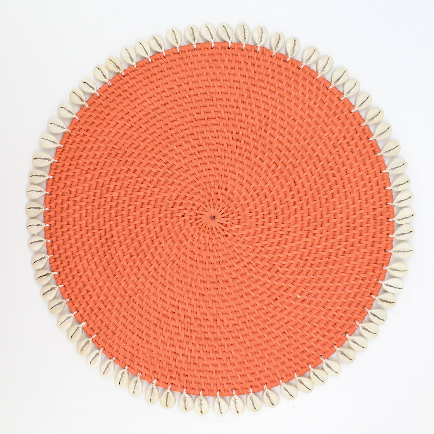 Handmade orange rattan placemat with natural seashell trim, shown on white background for clean, product-only display