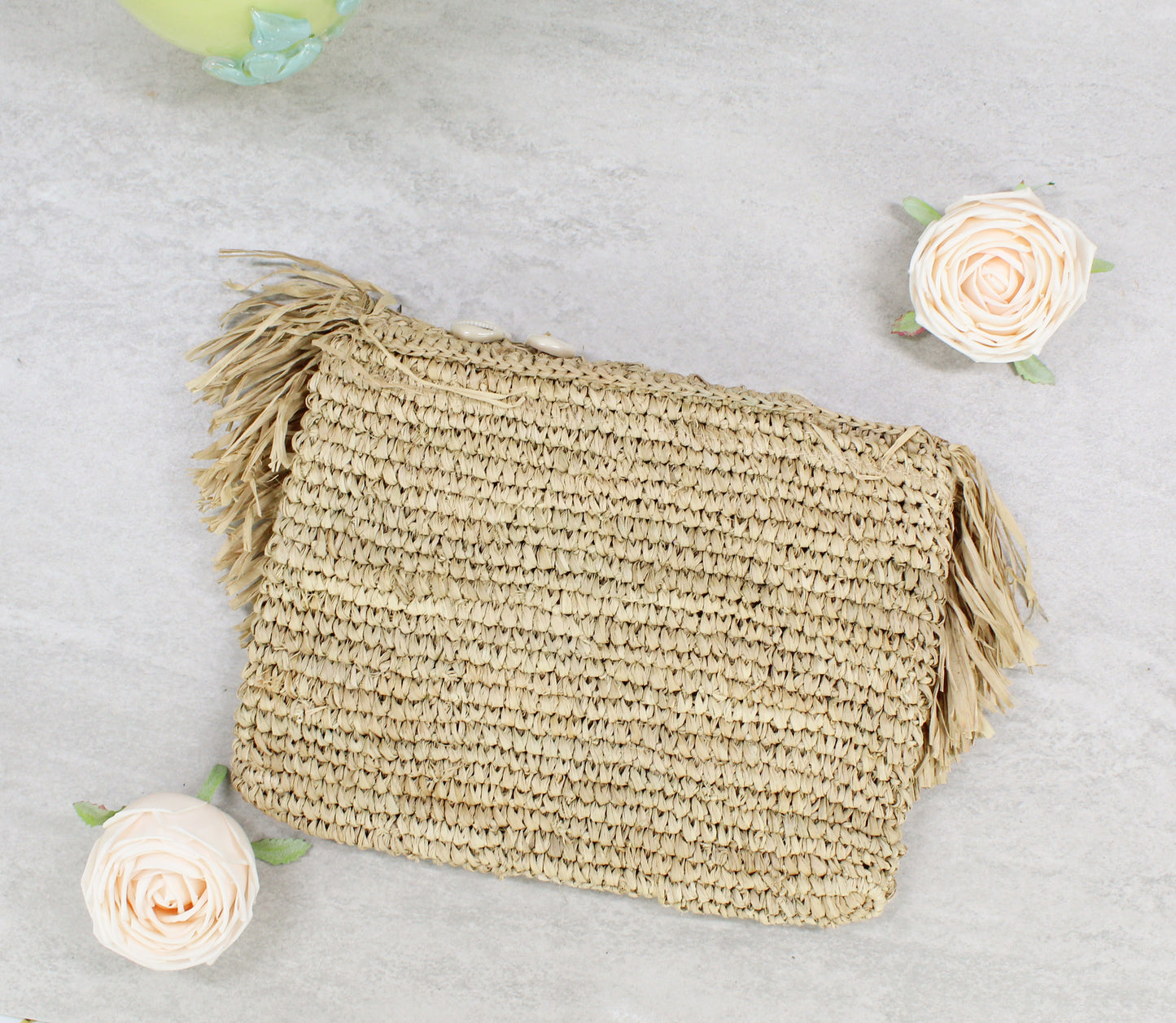 Back view of handmade raffia clutch showing natural woven texture and clean coastal finish.