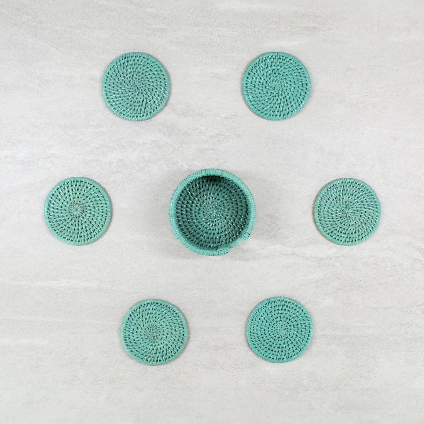 ECO HANDCRAFT turquoise rattan coaster set with holder, handmade for stylish sustainable table protection.