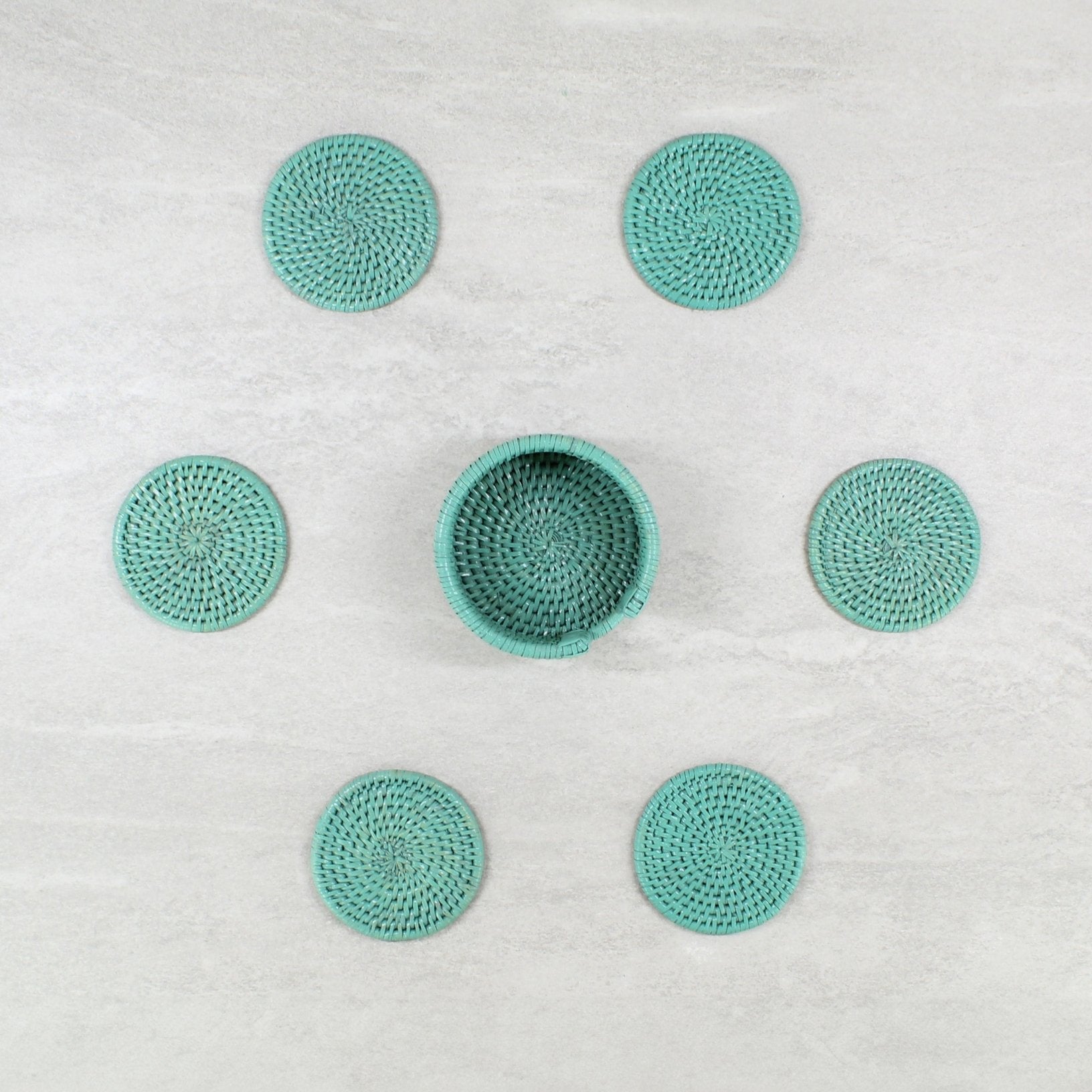 ECO HANDCRAFT turquoise rattan coaster set with holder, handmade for stylish sustainable table protection.