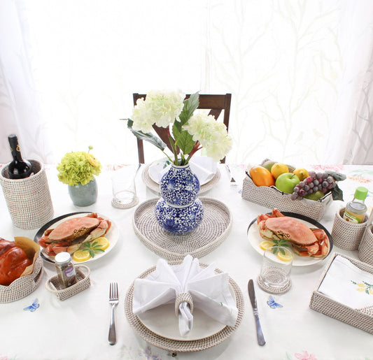 Eco Handcraft rattan tableware with wine holder, trays, and placemats styled for elegant seafood dining at home.