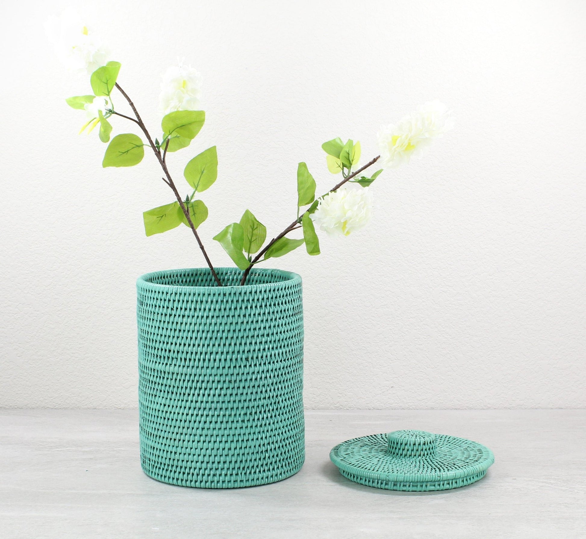 Eco Handcraft turquoise rattan canister styled as a flower vase, perfect for spa, vanity, or eco-friendly home décor