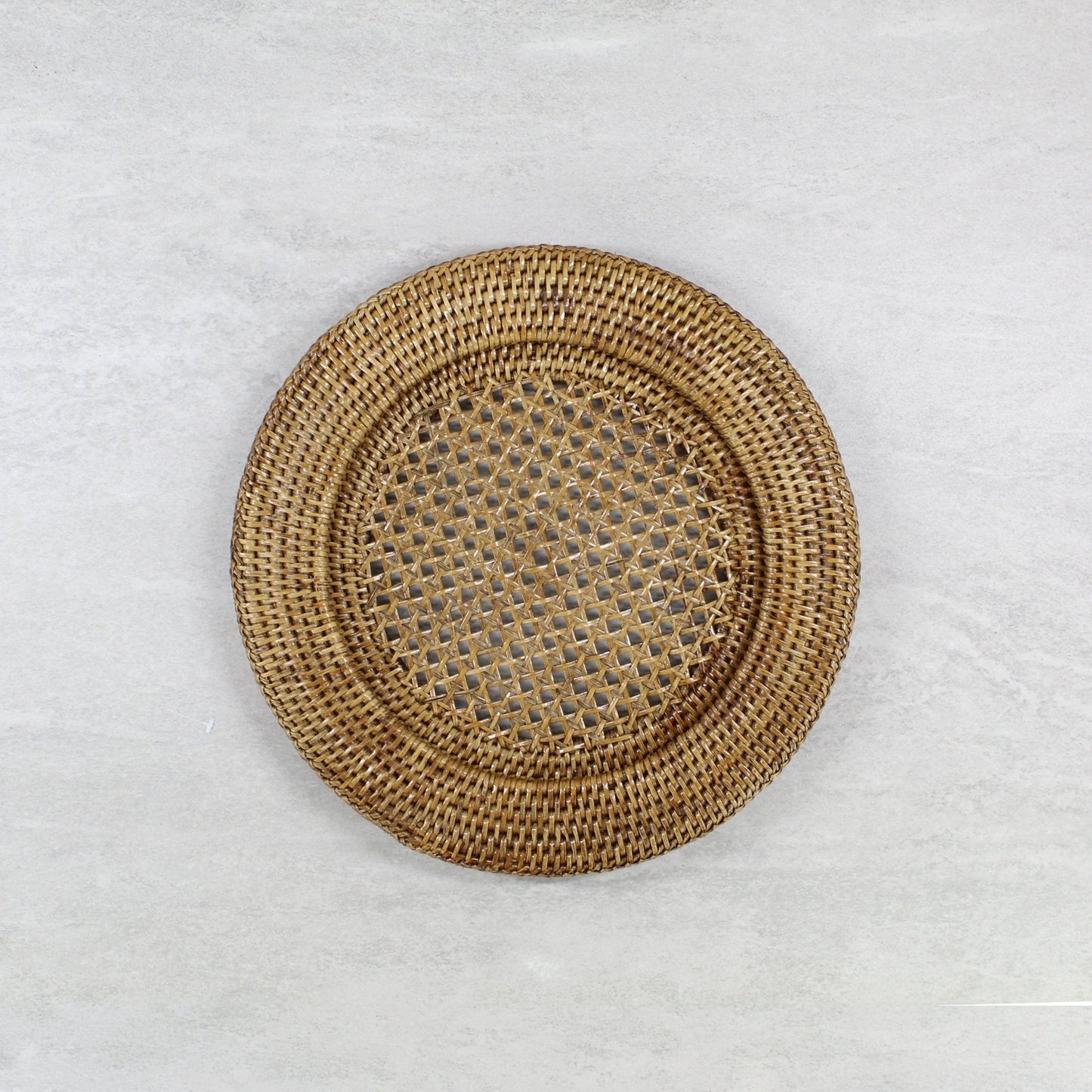 ECO HANDCRAFT open-weave brown rattan charger plate, handmade for rustic sustainable dining table styling.