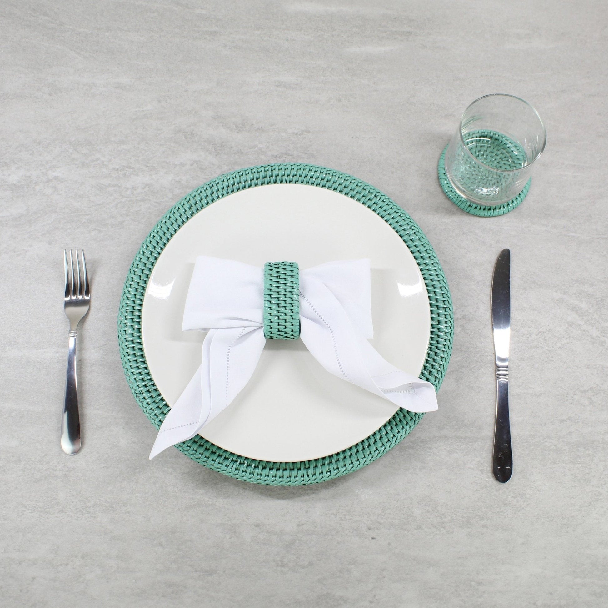 ECO HANDCRAFT turquoise rattan charger and napkin ring styled for elegant eco-friendly dining table decor.