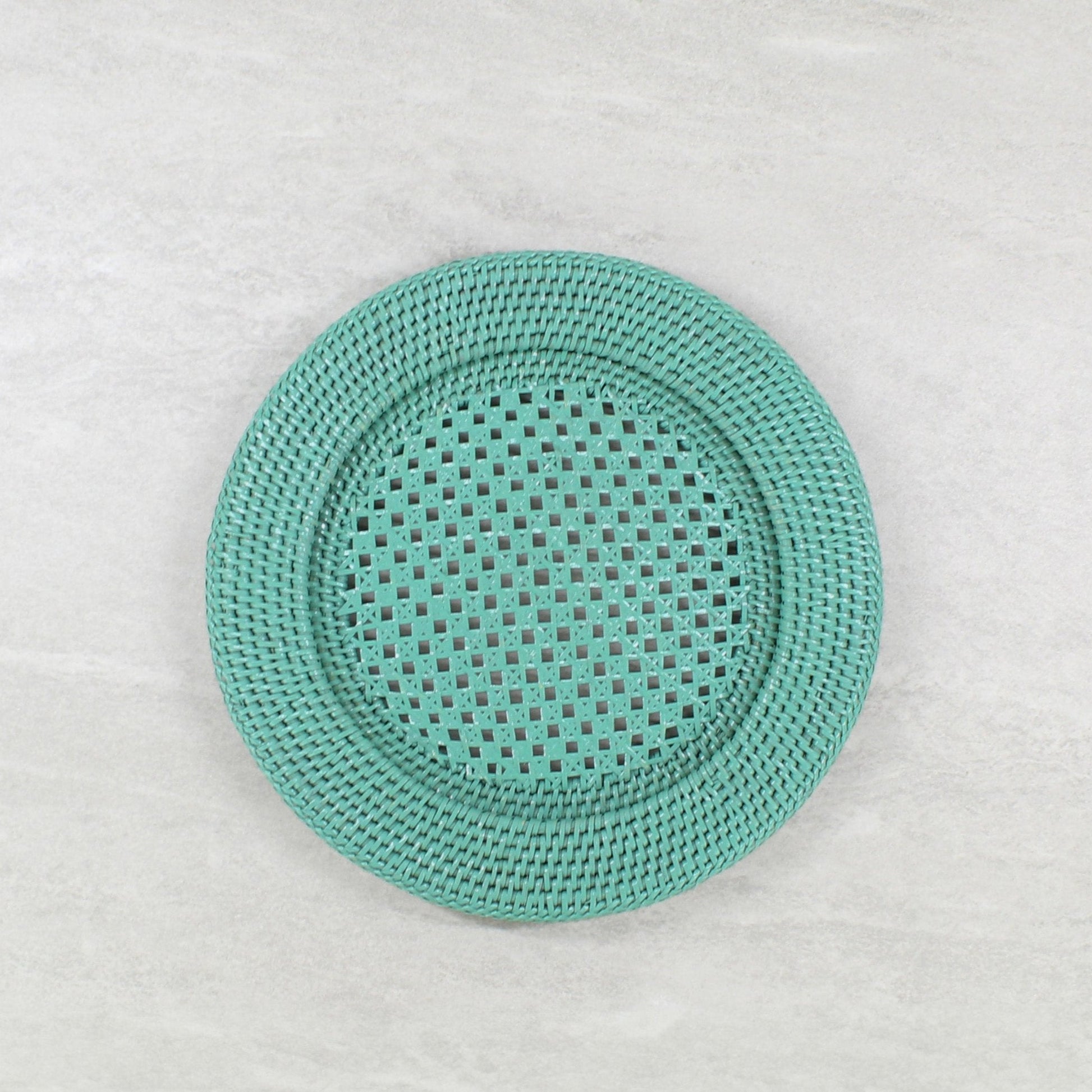 Handcrafted turquoise open-weave rattan charger plate by ECO HANDCRAFT for elegant eco-conscious dining.