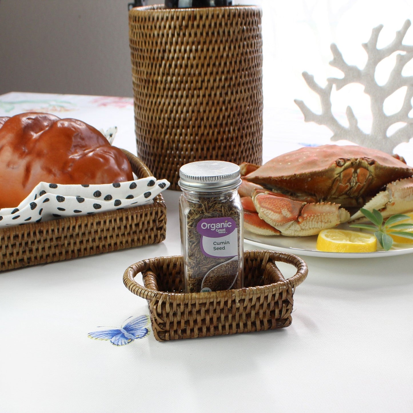 ECO HANDCRAFT mini rattan basket holding cumin jar on coastal table, perfect for spices or small essentials