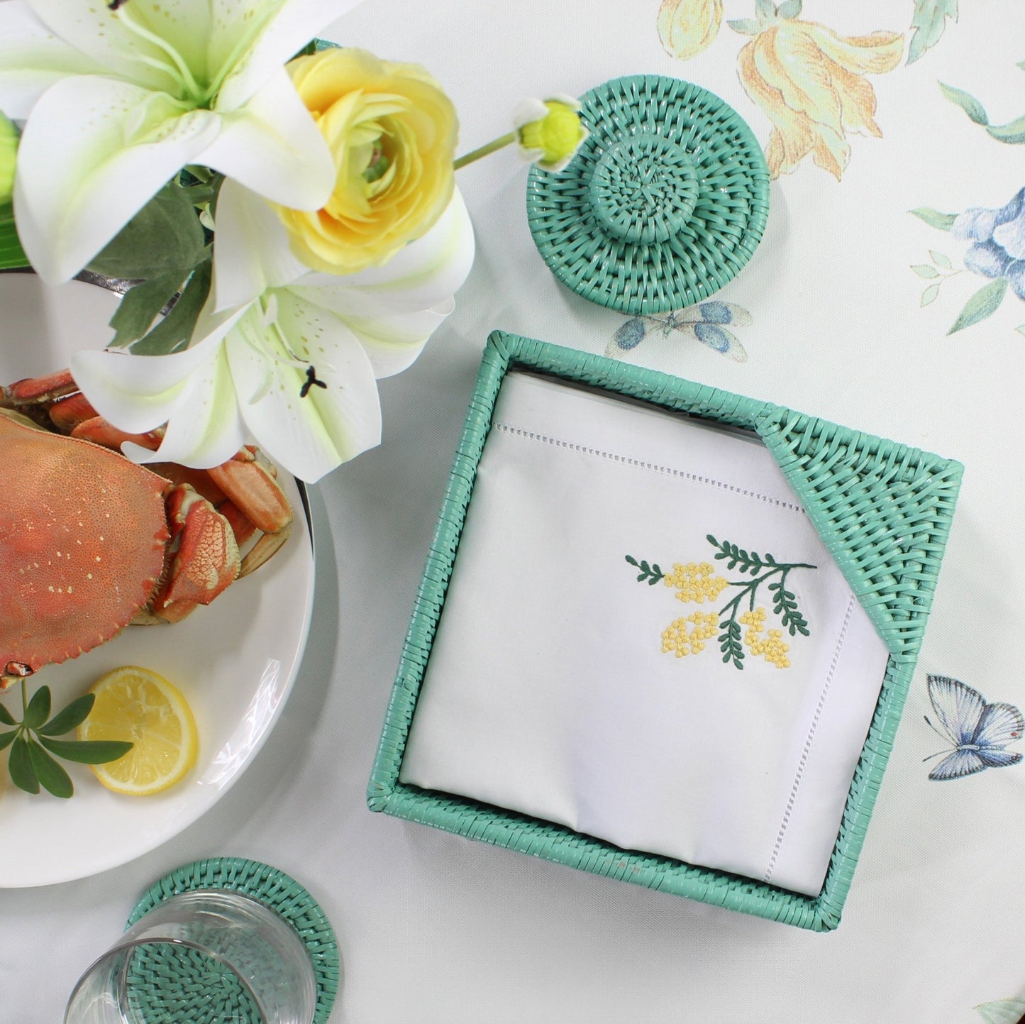 Eco Handcraft turquoise rattan napkin holder, coaster, and floral décor styled for coastal dining charm
