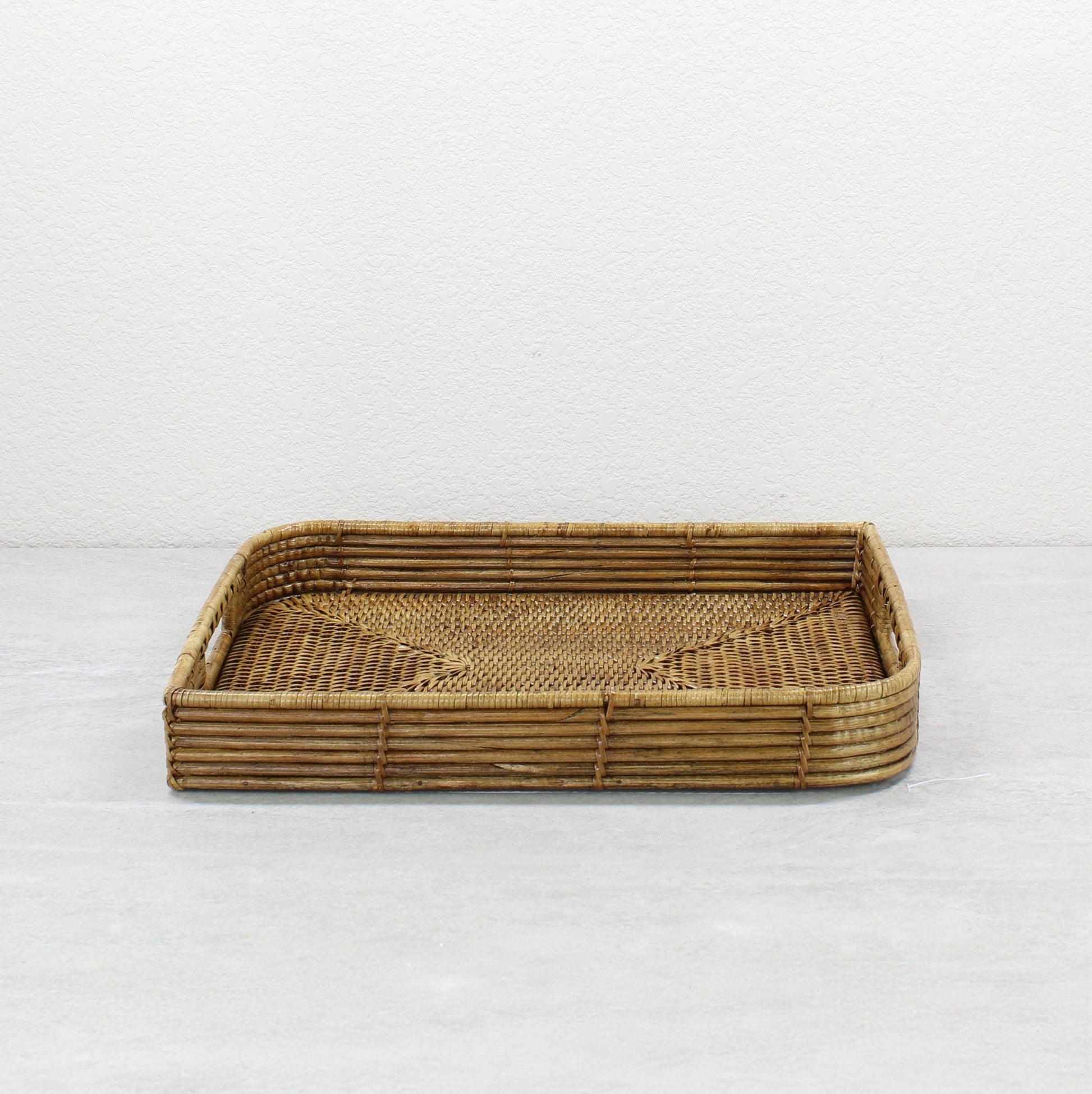 Handmade leaf shaped rattan tray with handles by ECO HANDCRAFT, ideal for serving, storage, or centerpieces
